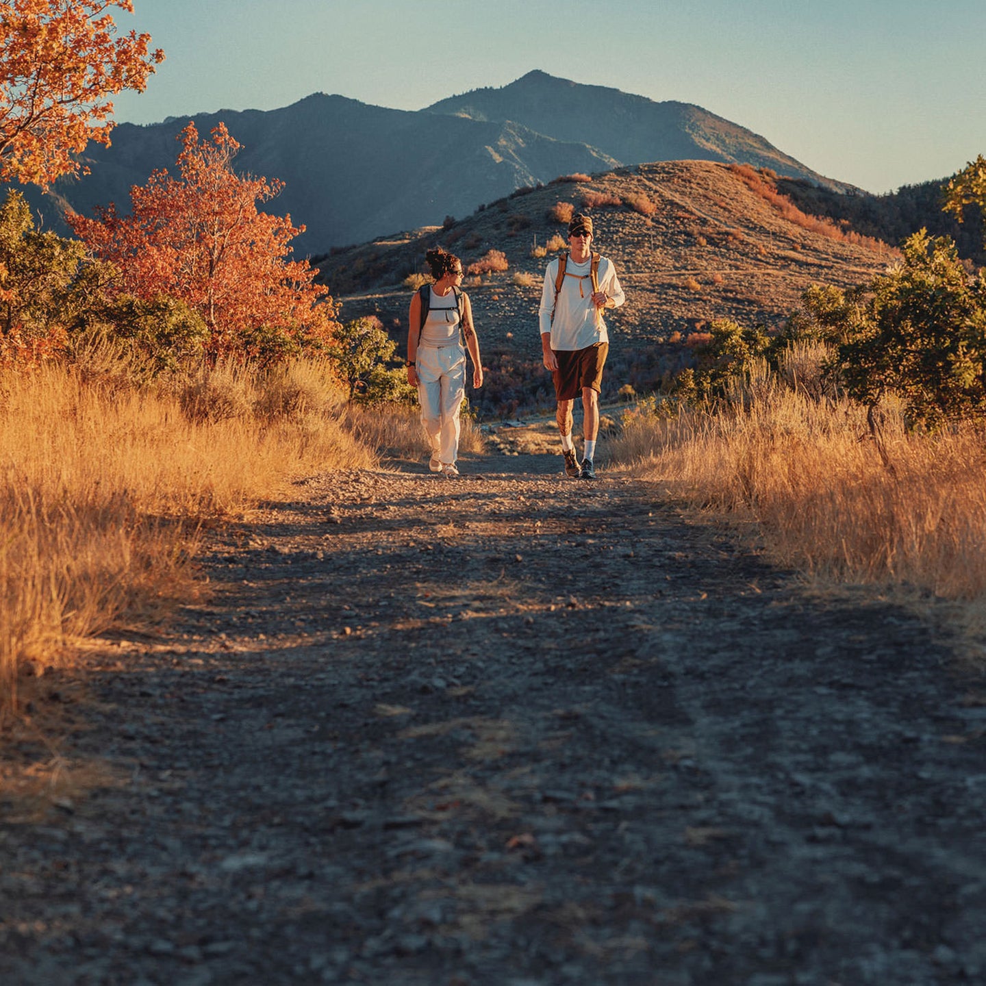 Two hikers wearing their Terros packs on a trail.
